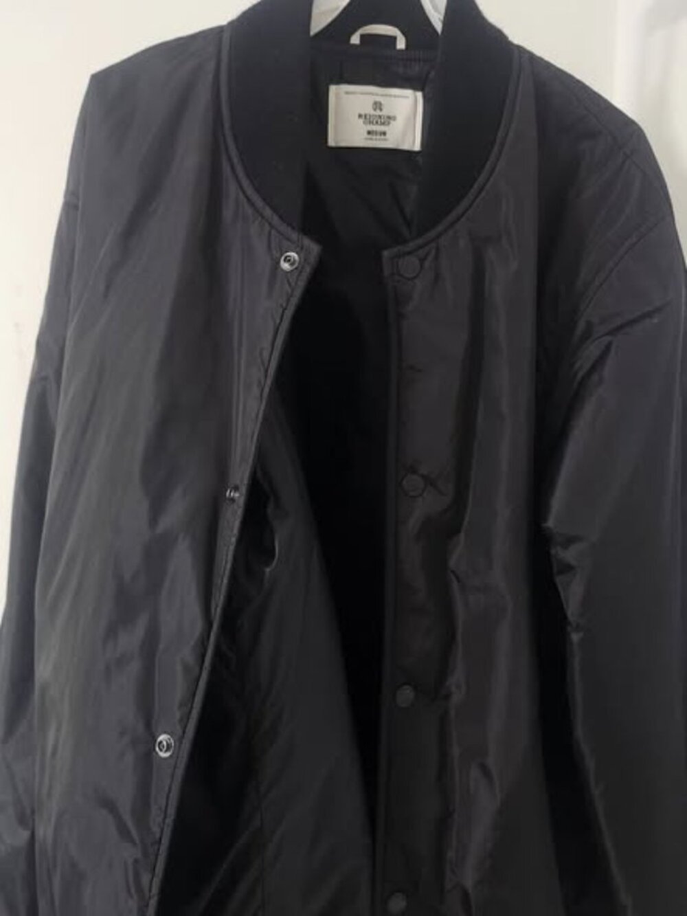 Men's Reigning Champ Econyl Satin Nylon Stadium Jacket in black, size Medium.